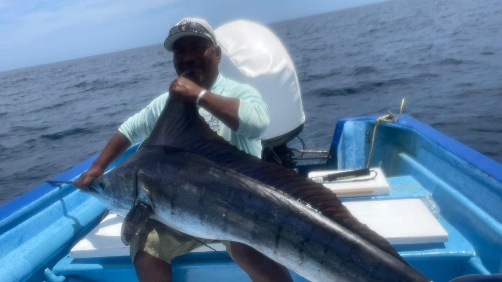 El capitán de Loreto Star sostiene la captura del día a bordo de la panga, en el Mar de Cortés